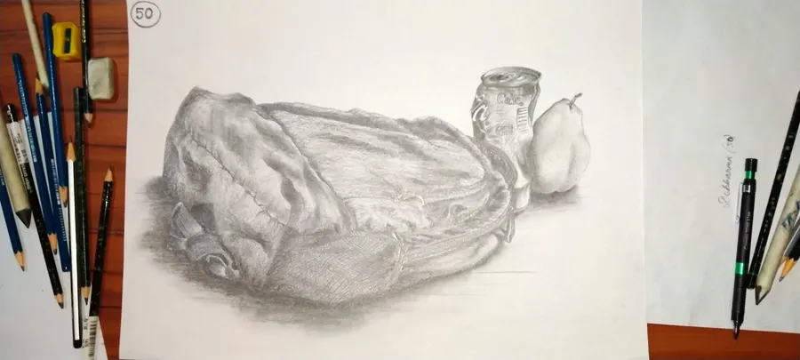 Graphite still life of a slouched backpack, a crushed Coca-Cola can and a pear, drawn on paper at the competition desk.